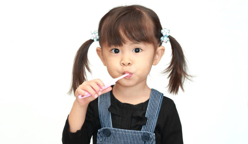 Young girl brushing her teeth