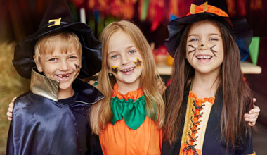 Smiling kids dressed up for Halloween