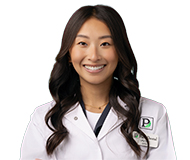 Dr. Lilly Vue smiling in a clinical jacket.
