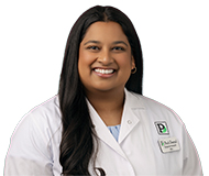 PatnayakShriparna-066_web Dr. Shriparna Patnayak, wearing a white coat with a Park Dental logo, smiles at the camera.