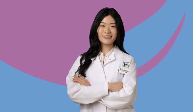Dr. Tori Tran in a clinical jacket smiling.